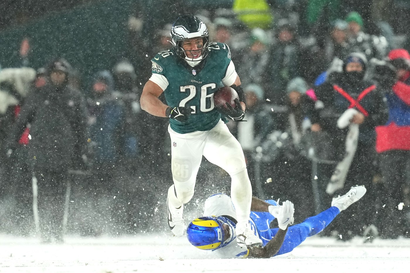 Barkley runs for 78- and 62-yard TDs in the snow and Eagles top Rams 28-22 to head to NFC title game