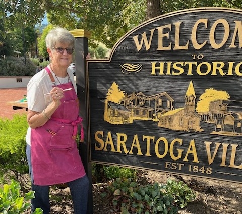 Volunteer paint job makes Saratoga Village sign more welcoming